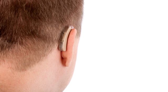 young man wearing a hearing aid