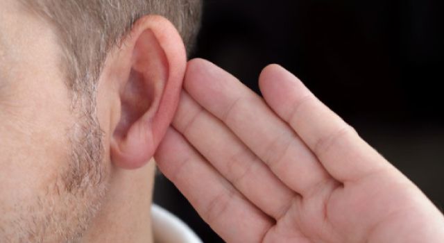 closeup of man putting his hand behind his ear