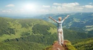 Woman enjoying the views on top of a mountain