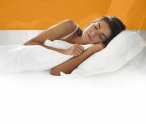 woman sleeping on a white bed