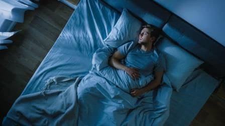 blog-hearing-loss-in-sleep-sm man in bed asleep