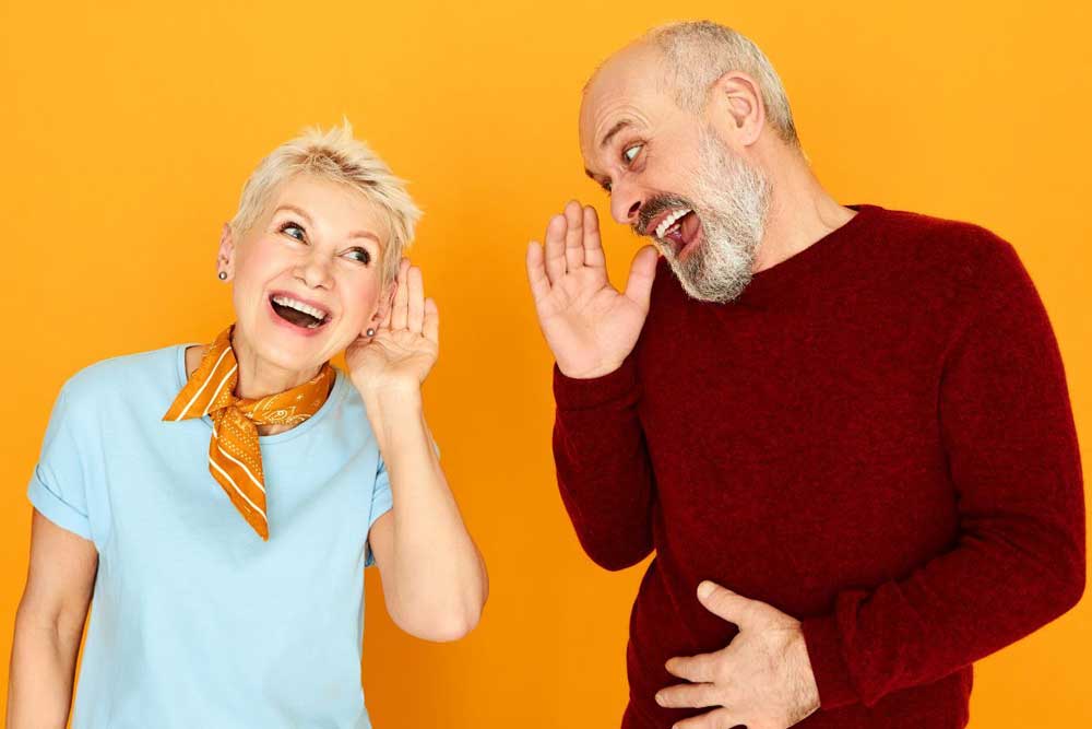 Man and woman with hearing difficulty laughing