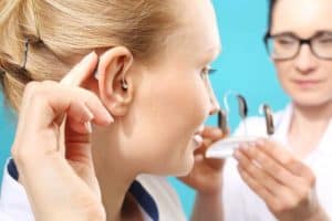 Woman testing different hearing devices