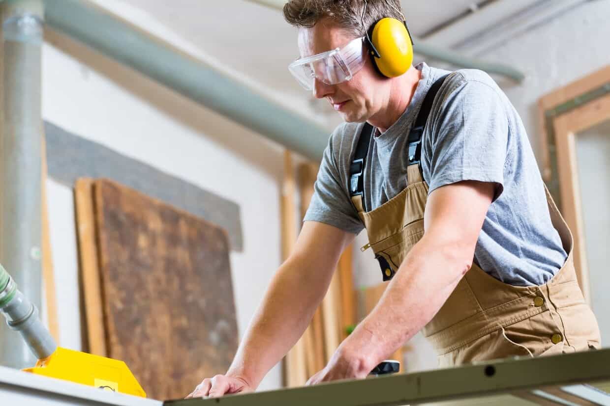 workplace hearing protection man in the shop wearing hearing protection headphones