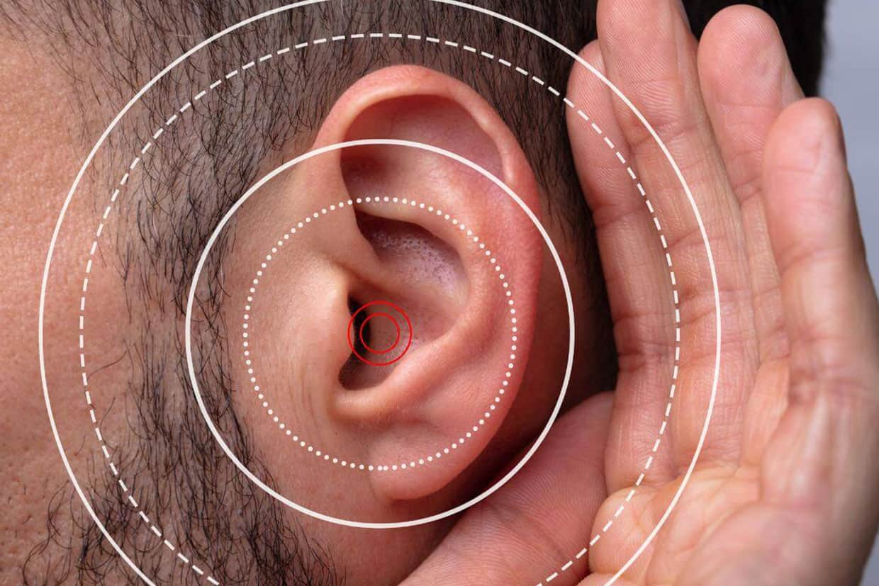 Image of a man zoomed in on his ear with ripples coming out of it