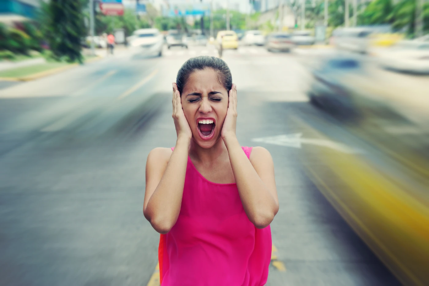 Women protecting her years from the city noise