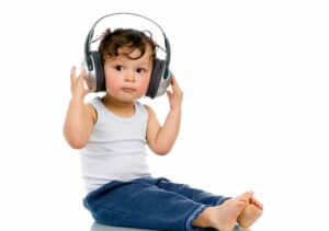 a toddler sitting on the floor with hearing protection