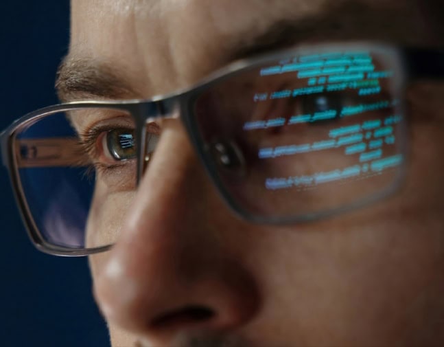 A man wearing live captioning glasses.