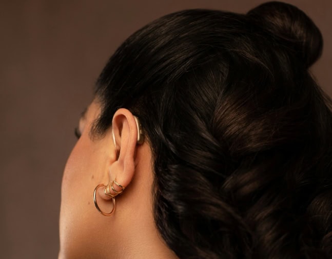 A young person is having challenges hearing at his workplace.