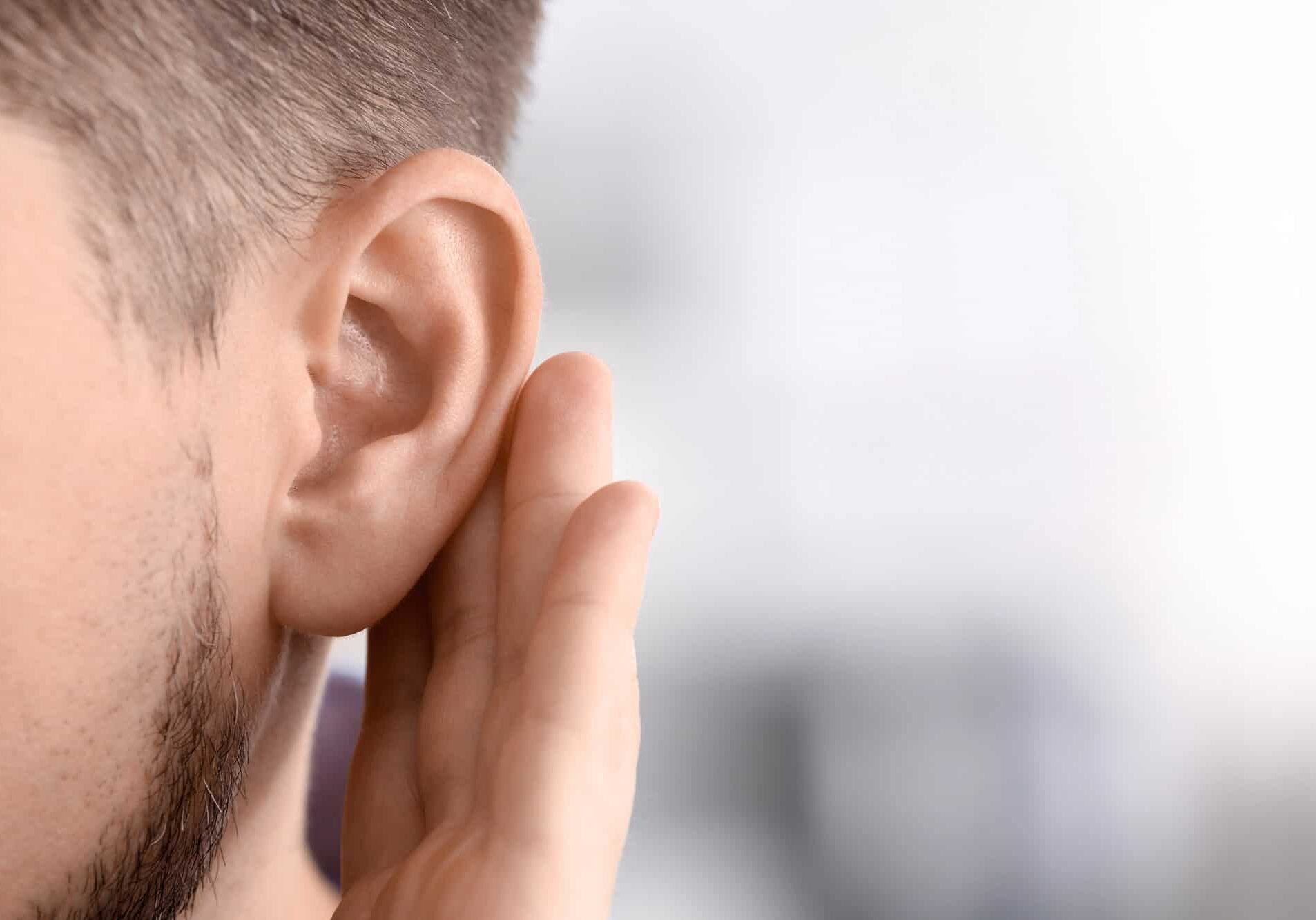 Person listening with hand raised