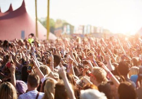 crowd of people raising their hand