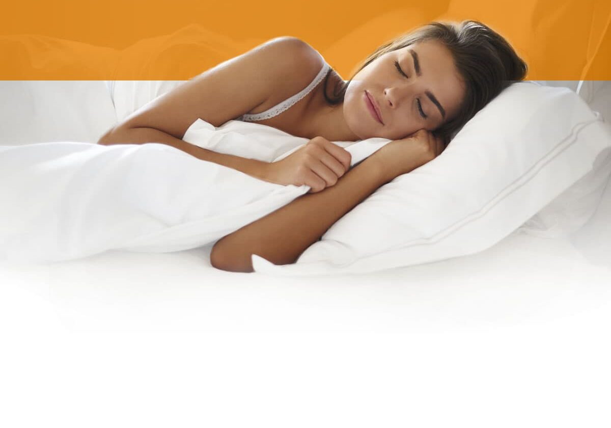 woman sleeping on a white bed