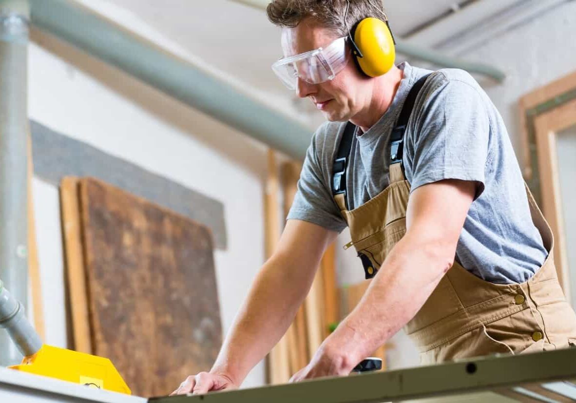 man in the shop wearing hearing protection headphones